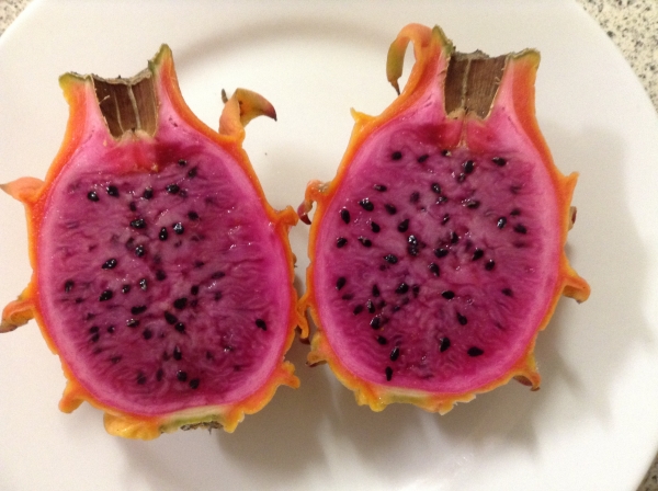 Frankies Red Dwarf Dragon Fruit ripe with red to purple flesh and black seeds split in half